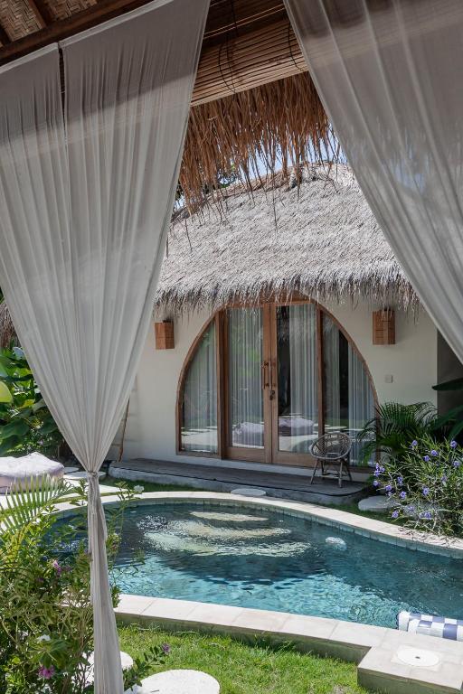 a resort with a swimming pool in the yard at Villa Nyantara - Private tropical villa in Gili Islands