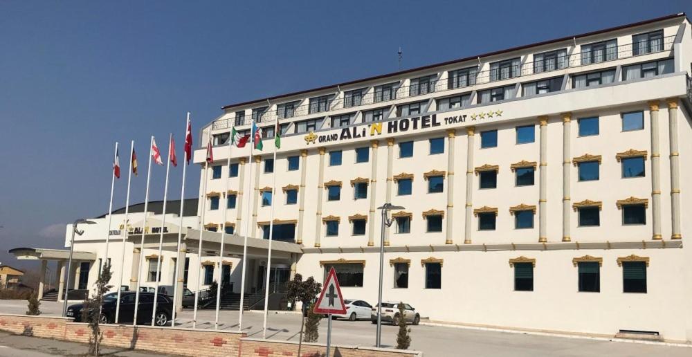 a white building with flags on top of it at Grand Ali'n Tokat in Tokat