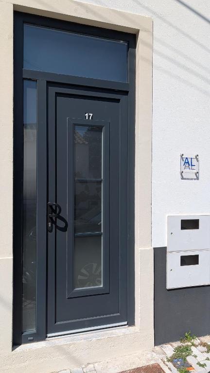 a black door on the side of a house at Casas Albano 1 in Caldas da Rainha