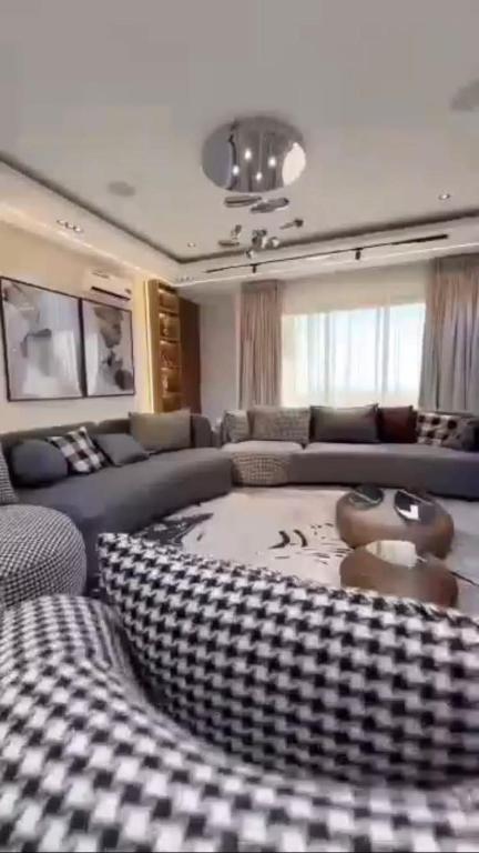 a living room with a couch and a table at Nimpat apartment in Lagos