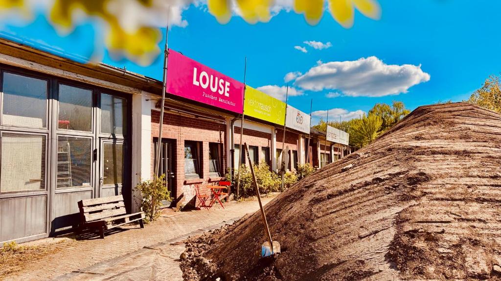 a building with a sign that says love on it at Louse Puschen Manufaktur in Kiel