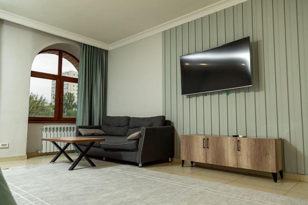 a living room with a couch and a table at Таугуль in Zhezdi