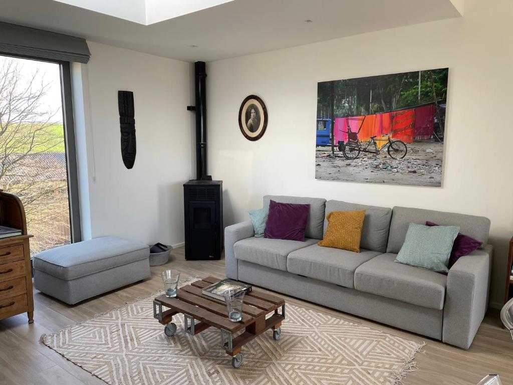 a living room with a couch and a coffee table at Les Gîtes de la Préale in Achet