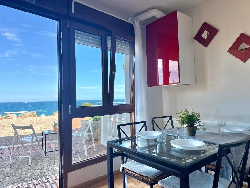 a dining room with a table and a view of the ocean at La Caseta - 5907 in Isla