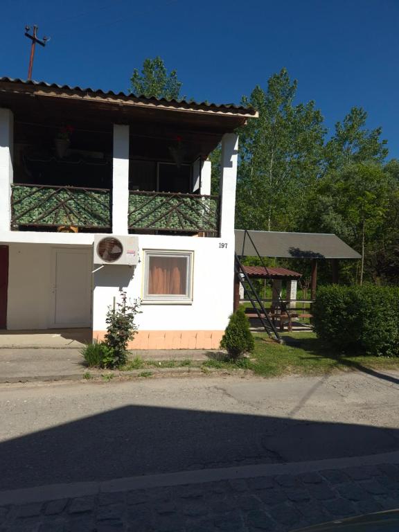 a white building with a window and a cross at Vikendica Bagremov hlad Apatin in Apatin