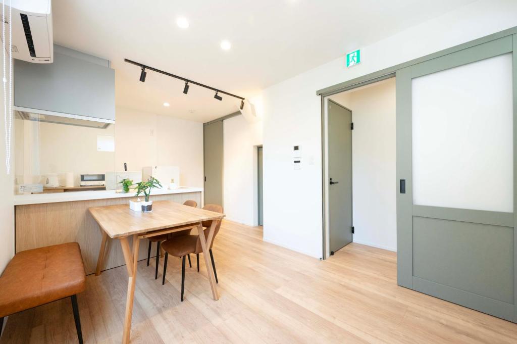 a kitchen and dining room with a table and chairs at HIKARIE Modern Stay Toyama in Toyama