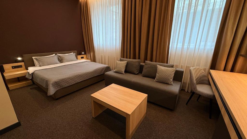 a hotel room with a bed and a couch at Готель Гоголь in Poltava