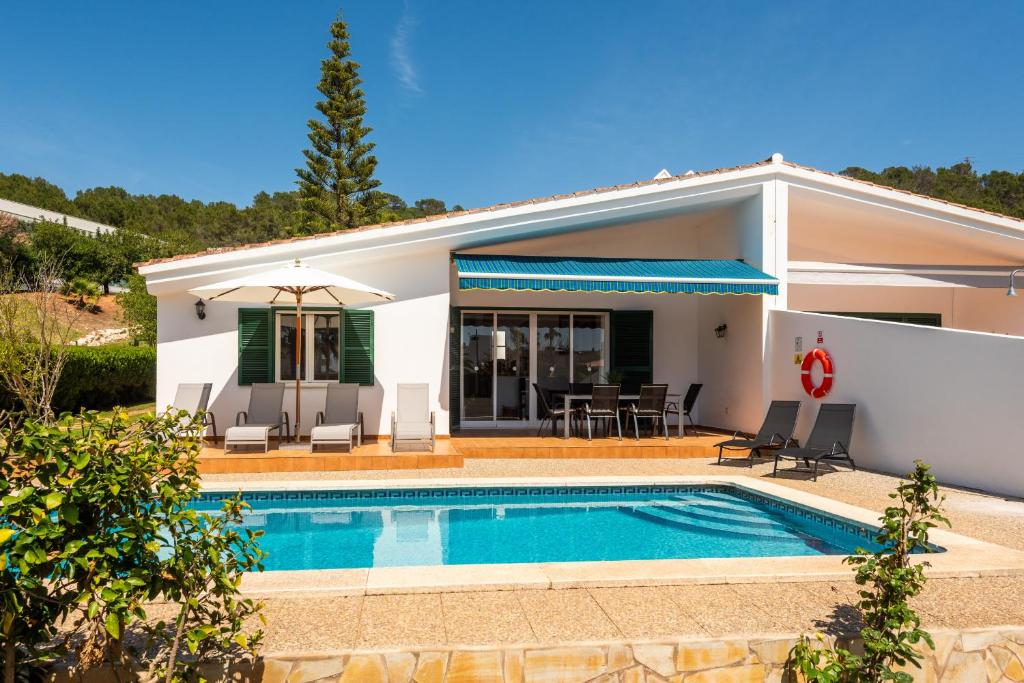 a villa with a swimming pool and a house at Villa Ca Mestre Rafel by Escape Home in Santo Tomás