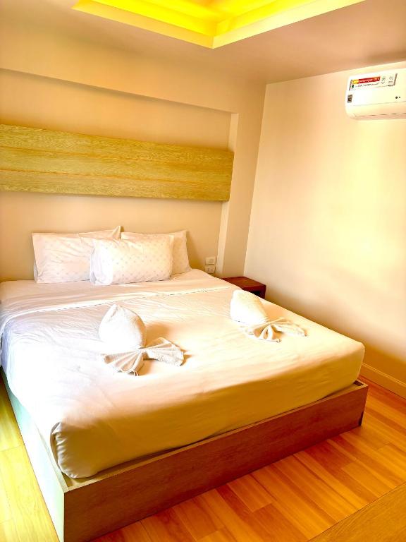 a bedroom with a bed with two bows on it at Adventure Condo Aonang in Ao Nang Beach