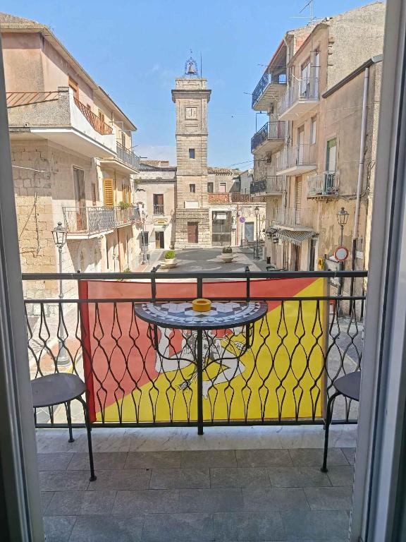 a table on a balcony with a view of a city at bed & breakfast Acquaviva di Vullo Vincenzo in Acquaviva Platani