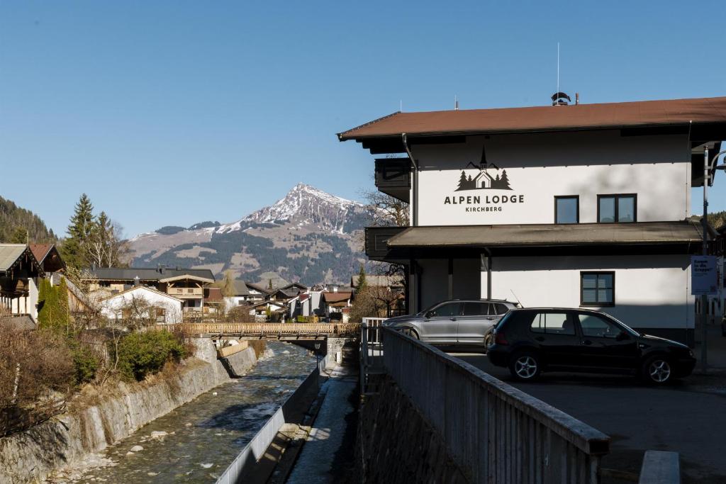a car parked in front of a building with a mountain at Alpen Lodge Kirchberg in Kirchberg in Tirol