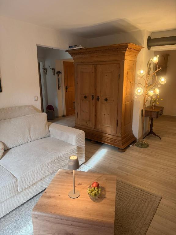 a living room with a white couch and a coffee table at Apartment Ape Maja in Bad Wiessee