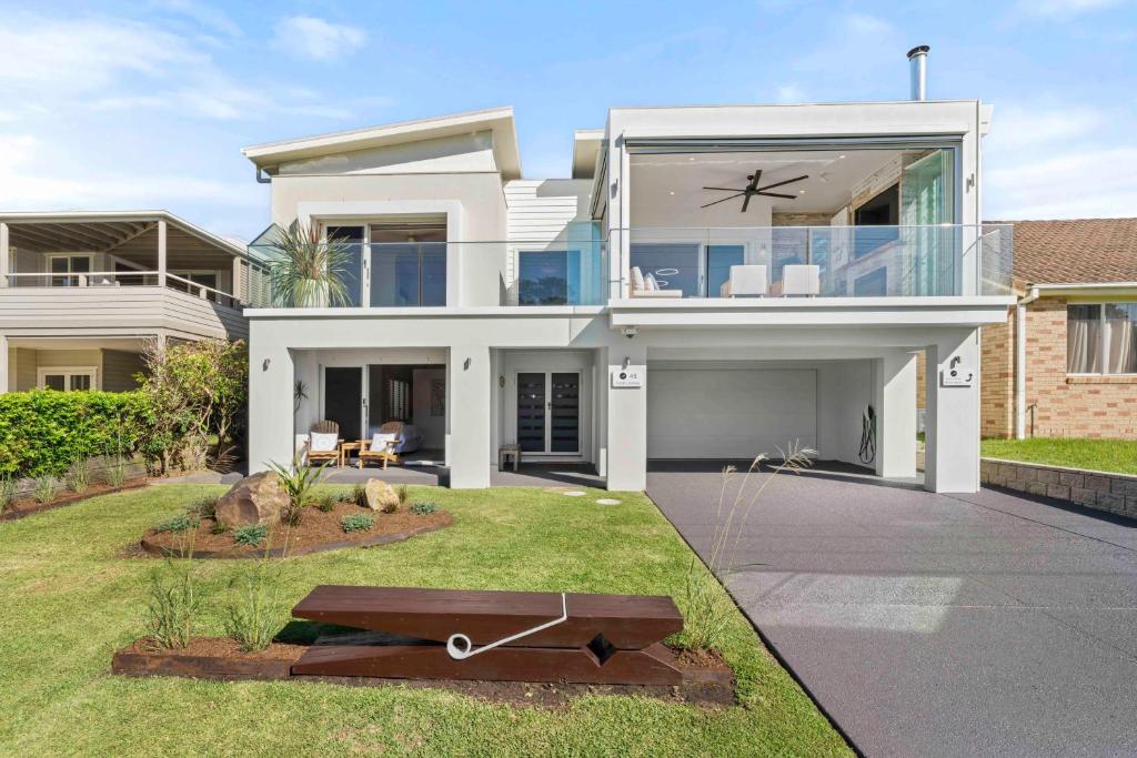 a large white house with a large window at Werri Big Beach House in Gerringong
