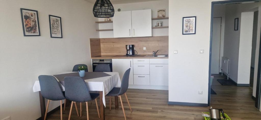 a kitchen and dining room with a table and chairs at Ferienwohnung Gipfelblick in Freyung