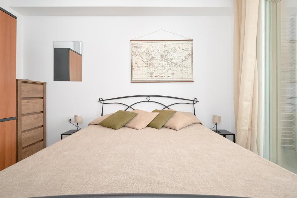 a bedroom with a large bed with two pillows at Casa vacanze vento di mare in Alghero