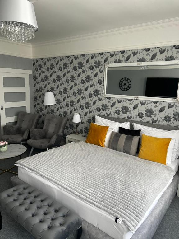 a bedroom with a large bed and a living room at The Manor in Pilsen