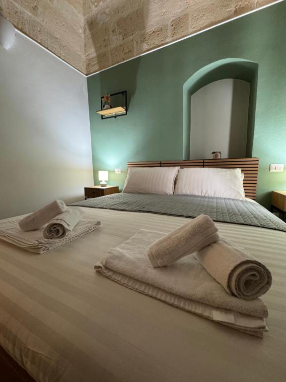 a bedroom with a bed with towels on it at Antico castello BeB in Altamura