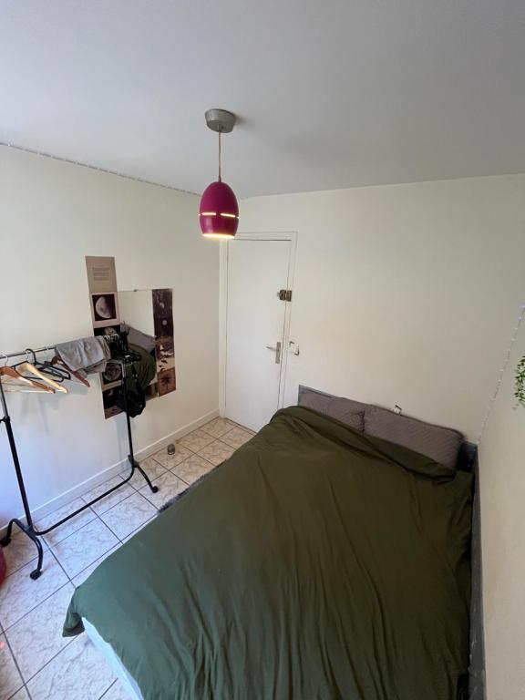 a bedroom with a bed and a camera in it at Chambre confortable in Saint-Maur-des-Fossés