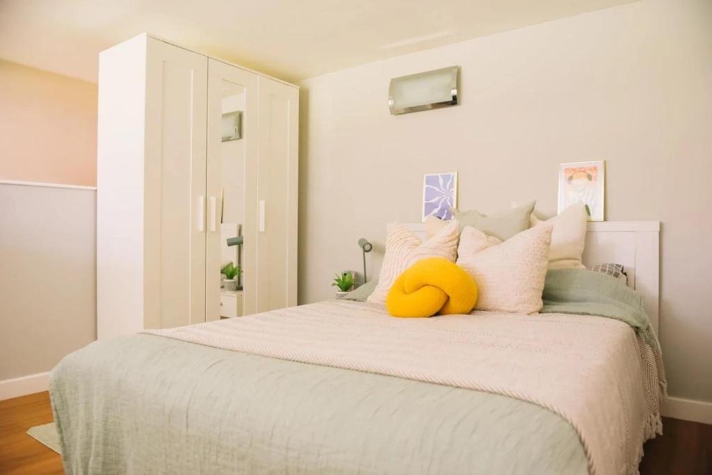a bedroom with a bed with a yellow stuffed animal on it at For Students Only - Library Lofts in Exeter in Exeter
