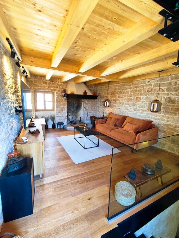 a living room with a couch and a brick wall at Casa Eddy in Bale