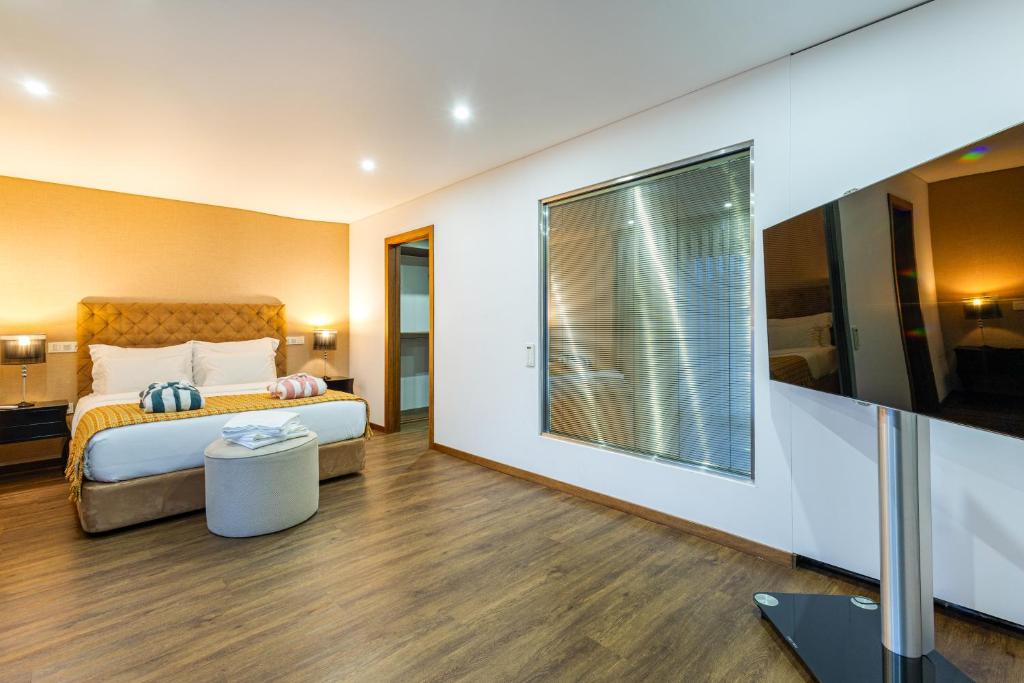 a hotel room with a bed and a large window at Luxury by ON Apartments in Porto