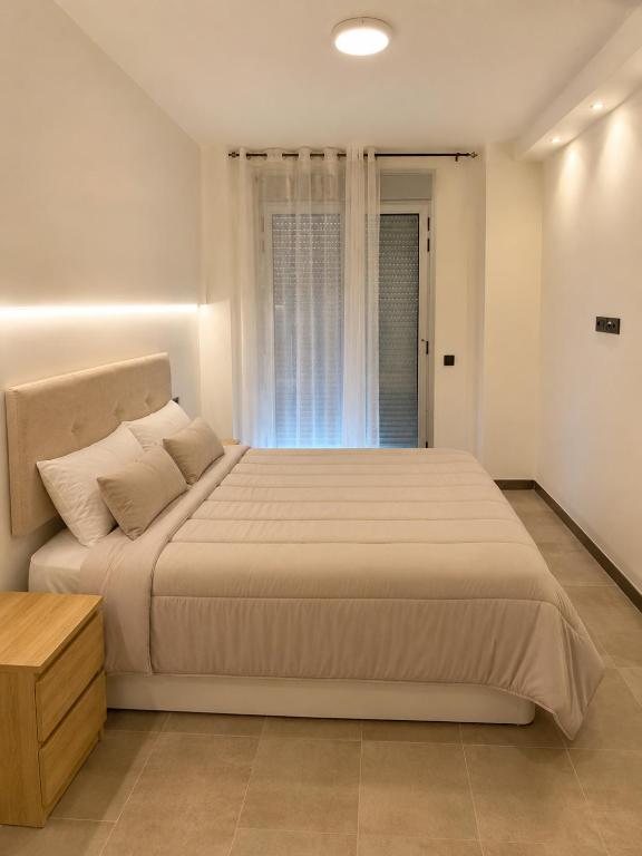 a bedroom with a large bed and a window at Residencial Lleida in Lleida