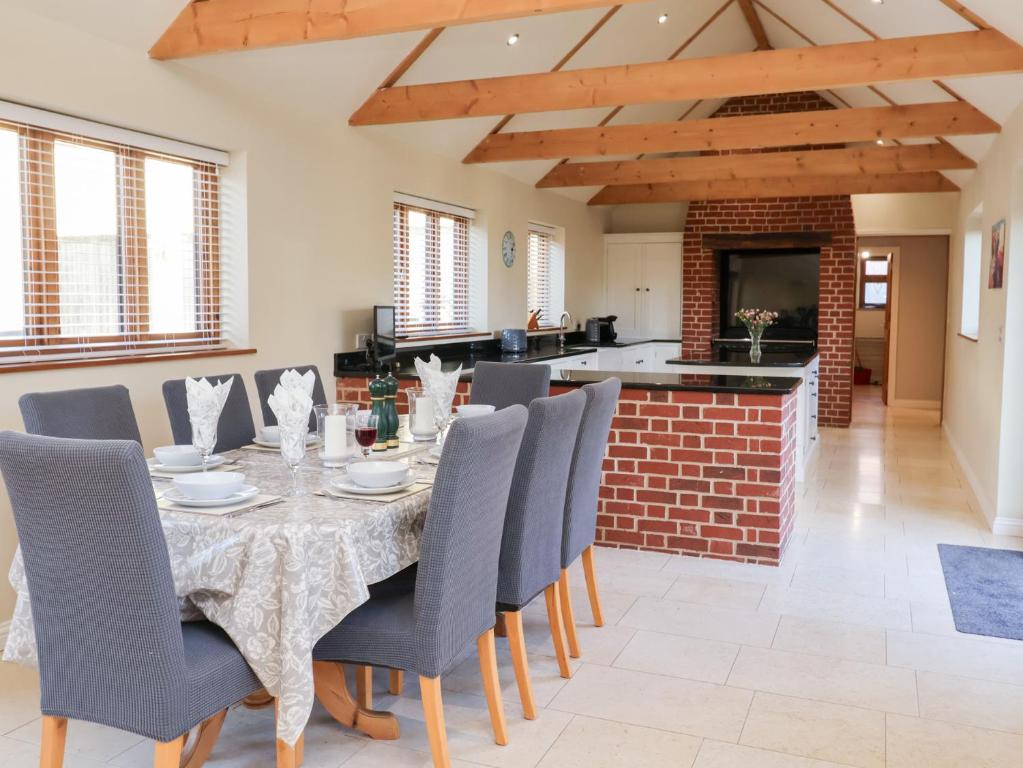 a dining room with a table and chairs at The Stables at Hall Barn in Diss