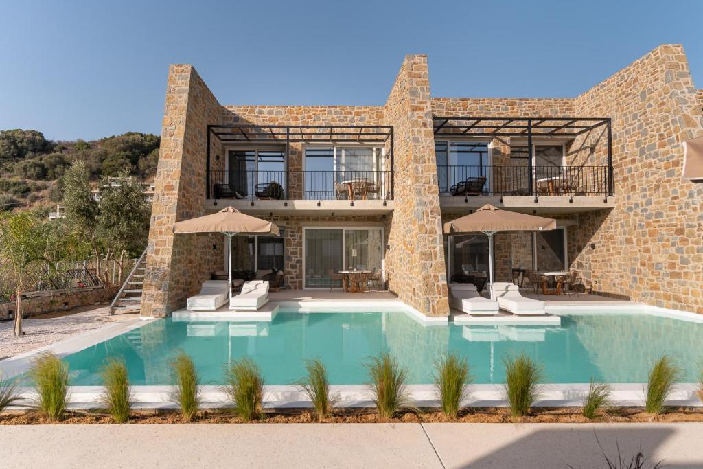 a house with a swimming pool in front of it at Gialova Hills 8 in Gialova