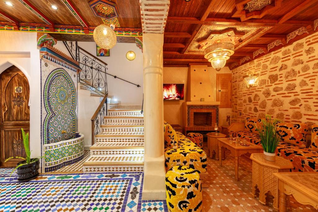 a room with a staircase with colorful tiles on the floor at Riad Sultan Chefchaouen in Chefchaouen