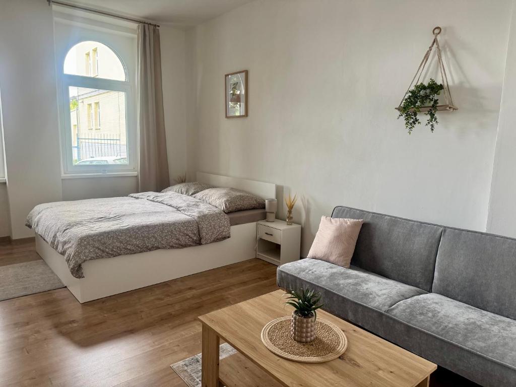 a living room with a bed and a couch at StayU Apartment in Ústí nad Labem