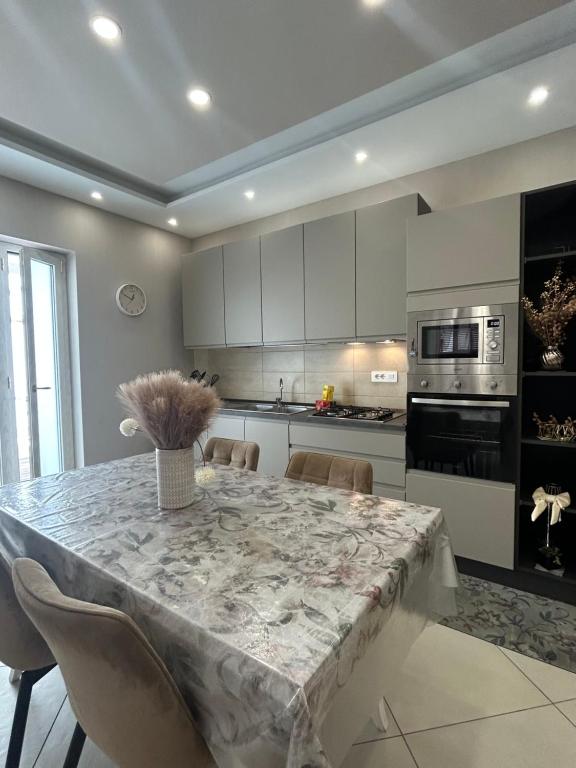 a kitchen with a table with a vase on it at Martone house in Castellammare di Stabia