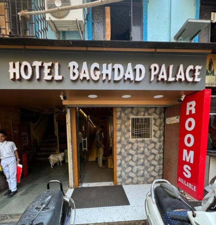 a hotel bagel palace sign in front of a building at Hotel Baghdad Palace in Mumbai
