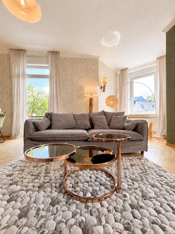 a living room with a couch and two tables at Stadtvilla Füssen in Füssen