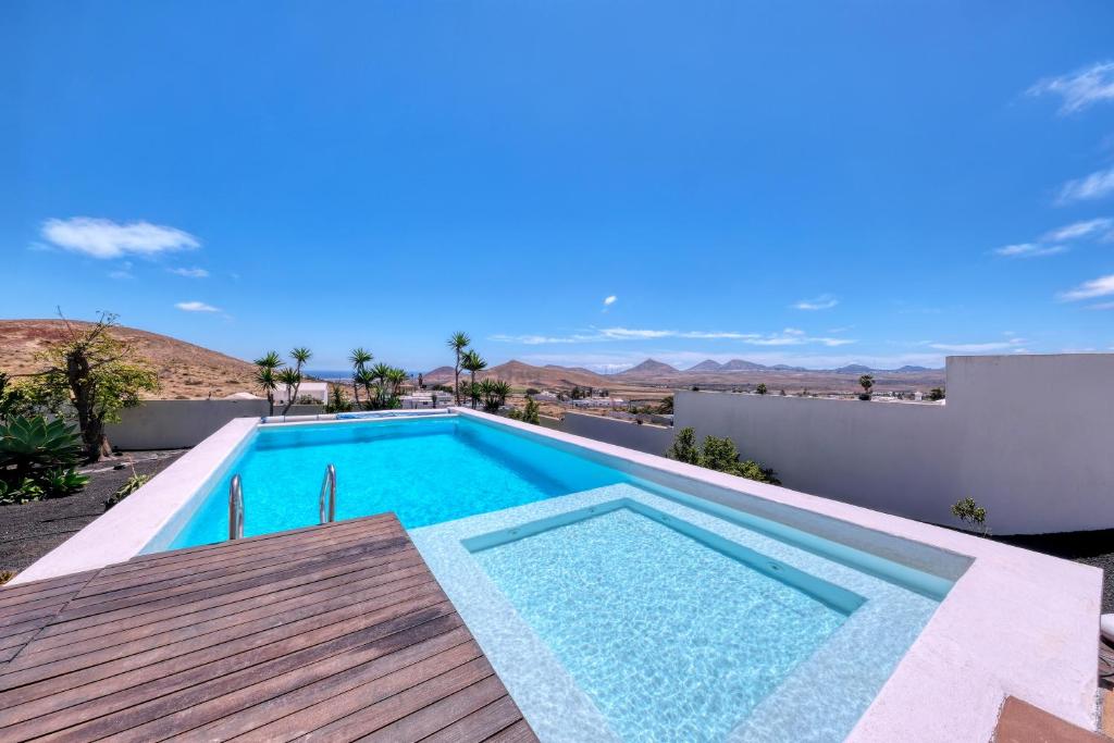 a swimming pool on the roof of a house at Villa El Erizo - Pool By Lanzarote Vacation Homes in Nazaret