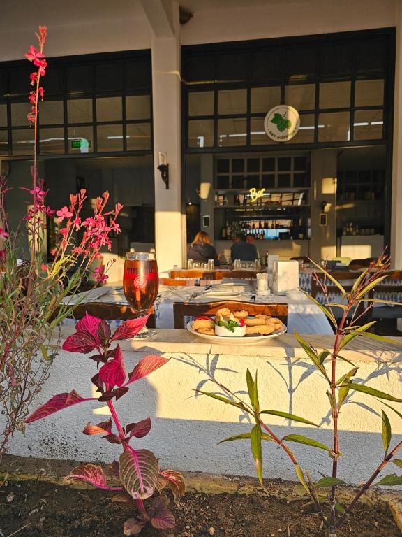 a table with a plate of food and flowers on it at Bluetopas Otel in İskele