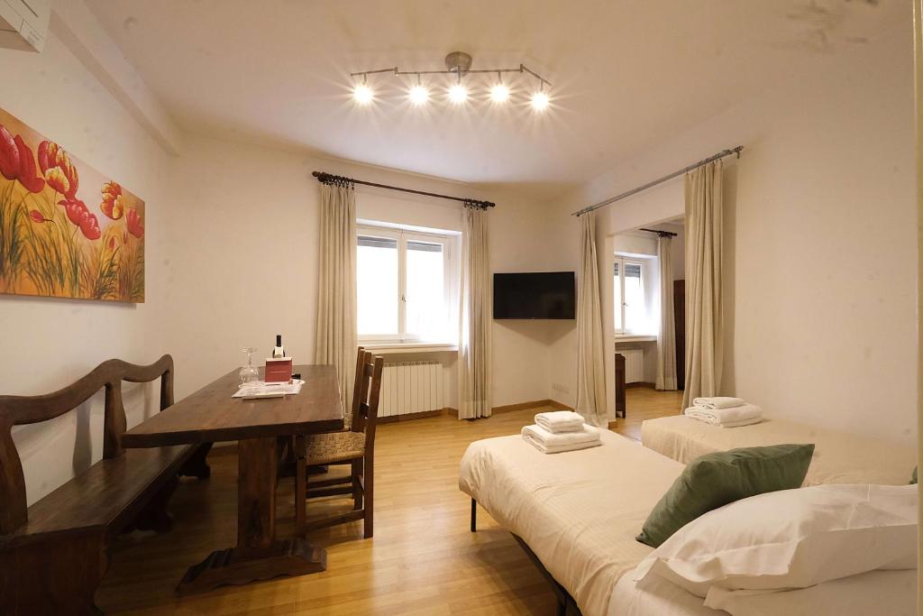 a room with a dining room table and two beds at Wine Apartments Florence Malvasia in Florence