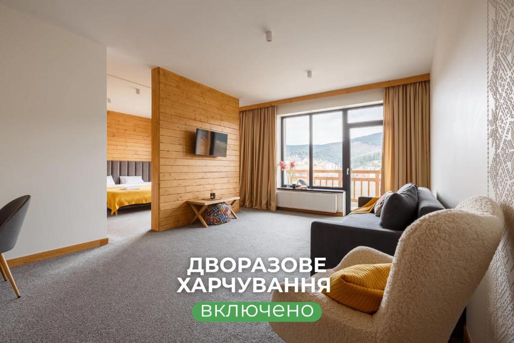 a living room with a couch and a tv at Yo Hotel in Bukovel