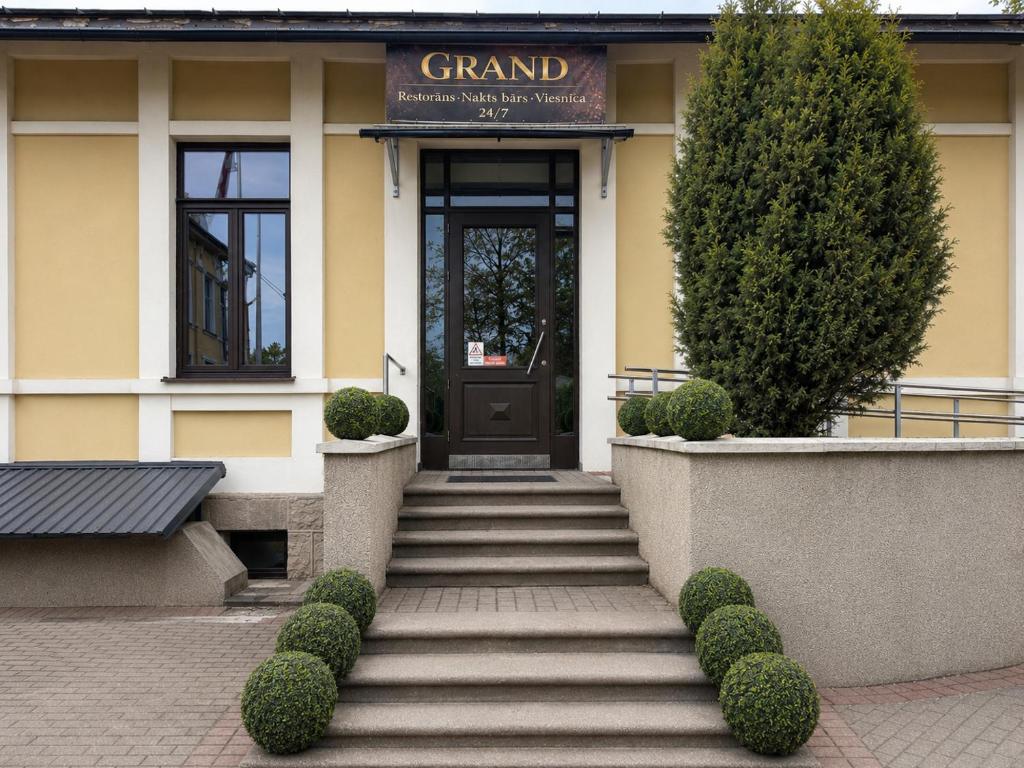 a building with a staircase in front of a door at GRAND Restaurant&Hotel in Daugavpils