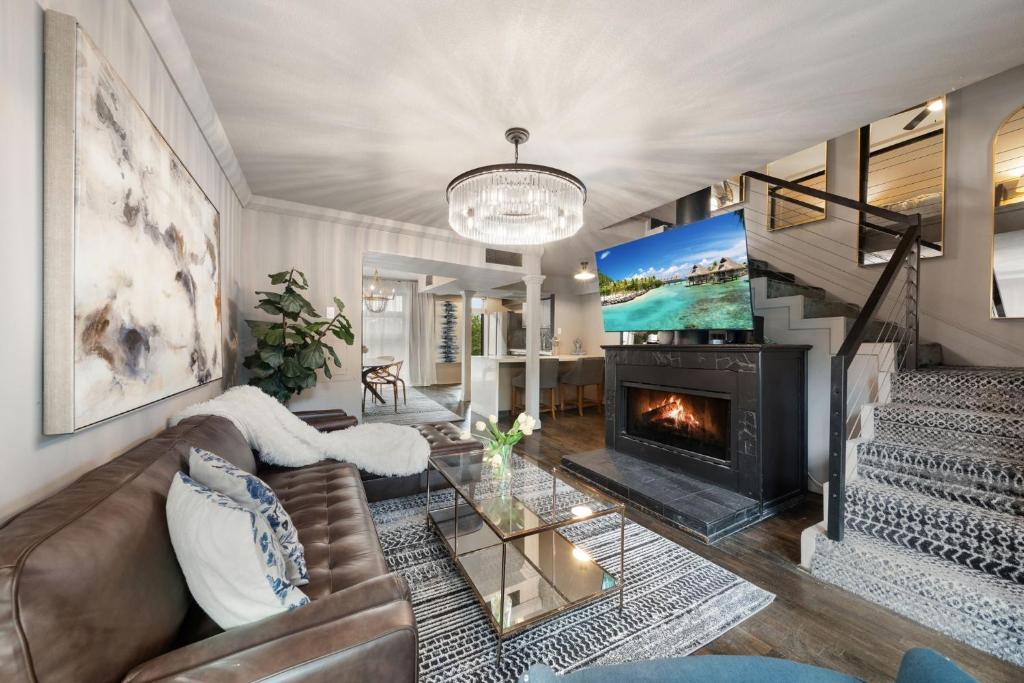 a living room with a couch and a fireplace at Spacious Loft Condo w Pool & Fireplace in Dallas