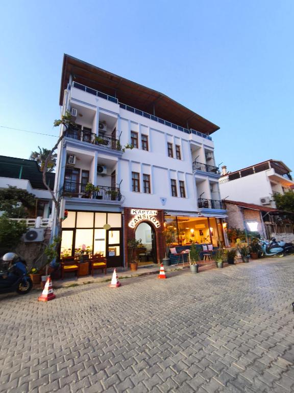 a large white building with cones in front of it at Kaptan Pansiyon in Kaş