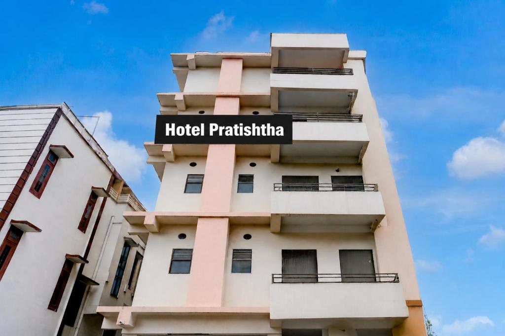 a hotel apartment building with a sign on it at Hotel Pratishtha in Guwahati