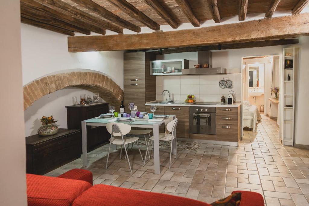 a kitchen with a table and a dining room at Bargello House by FrancigenaApartments in Siena