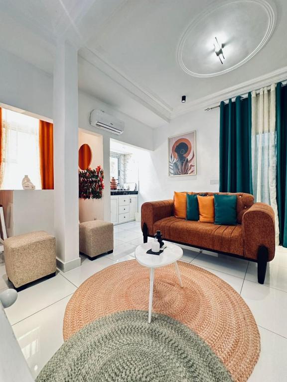 a living room with two couches and a table at Dyden luxury appartement in Douala