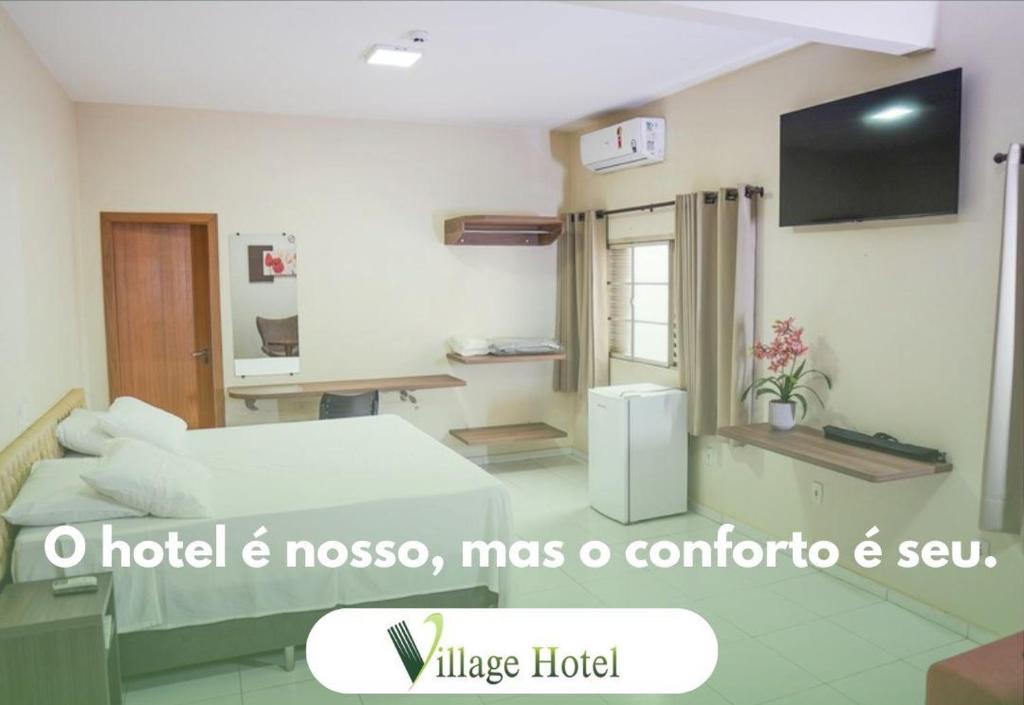 a room with a bed and a television in it at Village Hotel in Cáceres