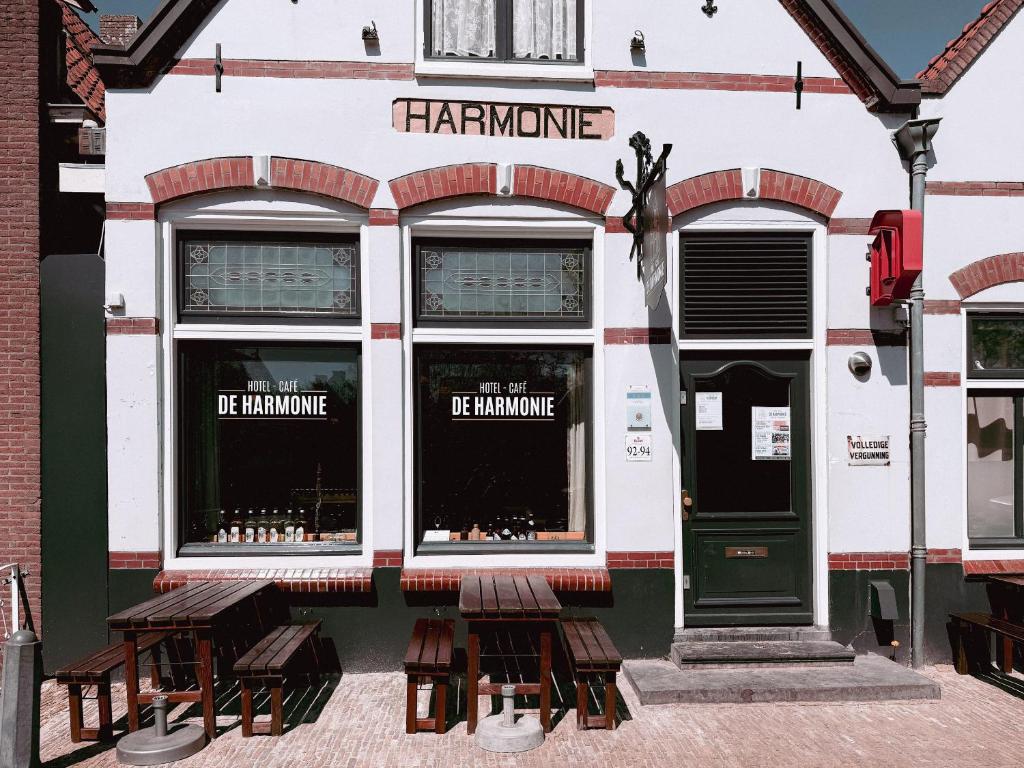 a store front with benches in front of it at Hotel - Cafe De Harmonie in Edam