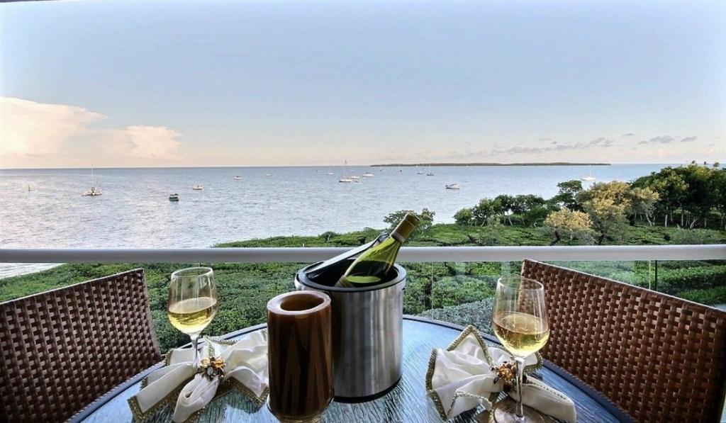 a bottle of wine sitting on a table with wine glasses at 334 Mariners Club in Key Largo