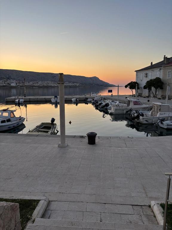 a group of boats docked in a marina at sunset at Laguna Rooms in Pag