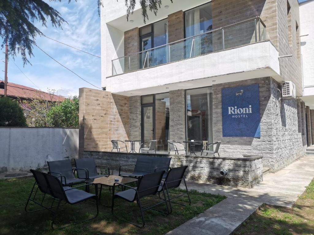 a table and chairs in front of a building at Hostel Rioni in Kutaisi