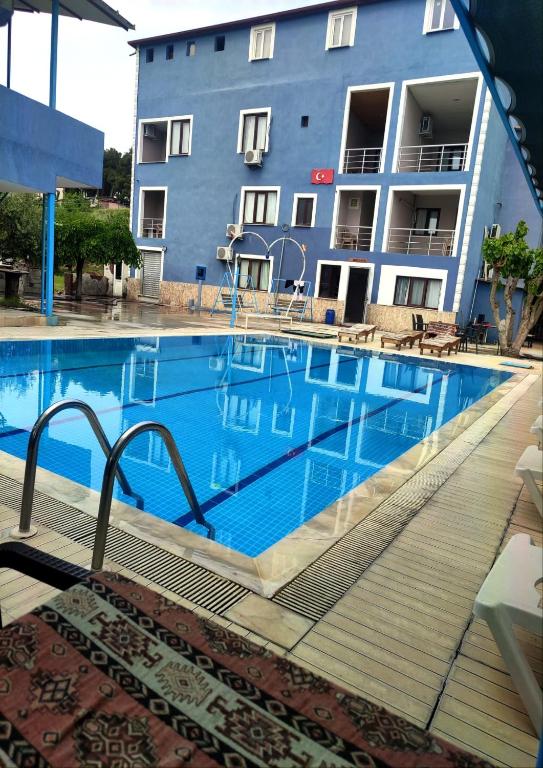 a large swimming pool in front of a building at Anatolia Hotel in Pamukkale