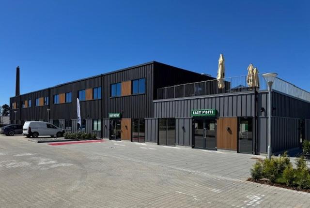 a building with a parking lot in front of it at Easy Stay Næstved in Næstved